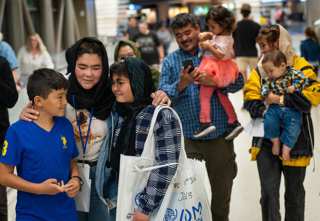 The Hussaini family are pictured hugging and chatting, after being reunited at Salt Lake City airport.