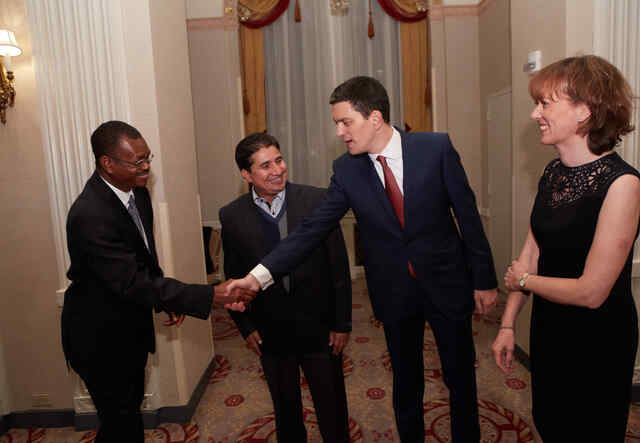 Vital shaking hands with the IRC's CEO and President, David Miliband.