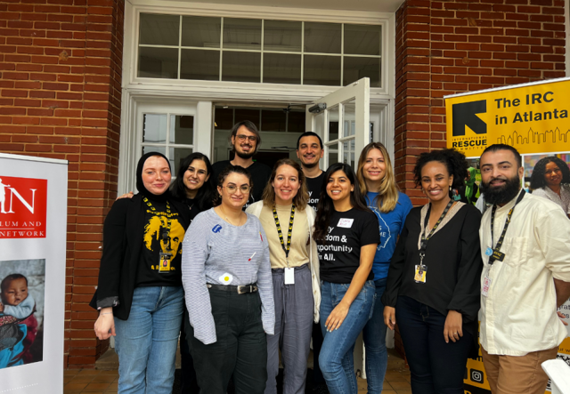 A group photo of IRC and GAIN staff standing outside of a TPS workshop.