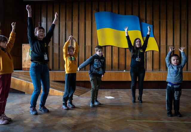 Children in Ukraine join IRC staff in an activity hosted at a Safe Healing Learning Space.