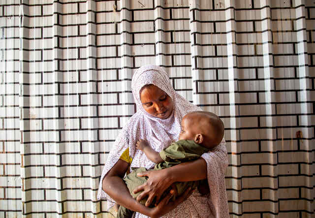 Fartun holds her baby son Salman.