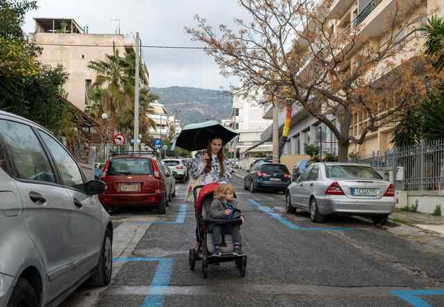 Khrystyna pushes her four-year-old son in a stroller in Athens, Greece.