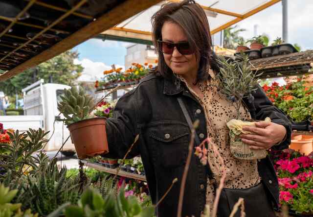 Alisa picks up a couple of plants while shopping.