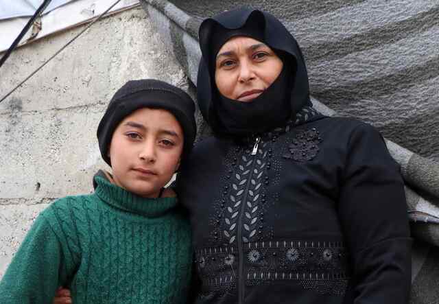 Mustafa poses for a photo with her son.