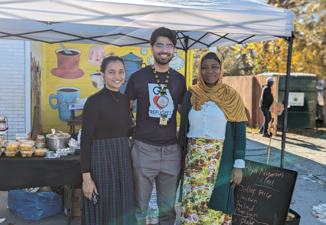 Hetal Soni, Sultan Minhas, and Nimota Salami standing shoulder to shoulder in front of the Royal Nigerian pop-up tent.