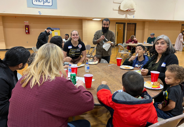 A table of IRC Atlanta staff and some of their children.