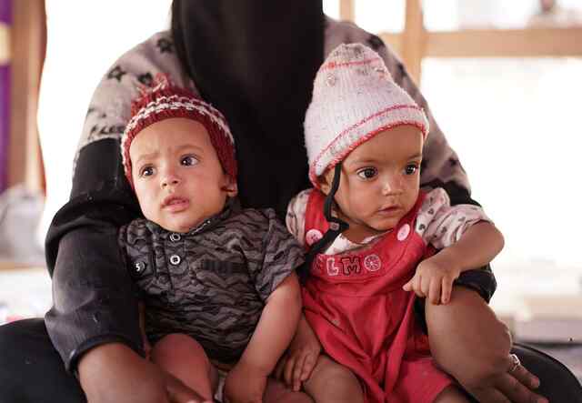 Asriya's twins Asma Abdo, 9 months old, and Abdo Ali Abdo, 9 months old, inside their camp.