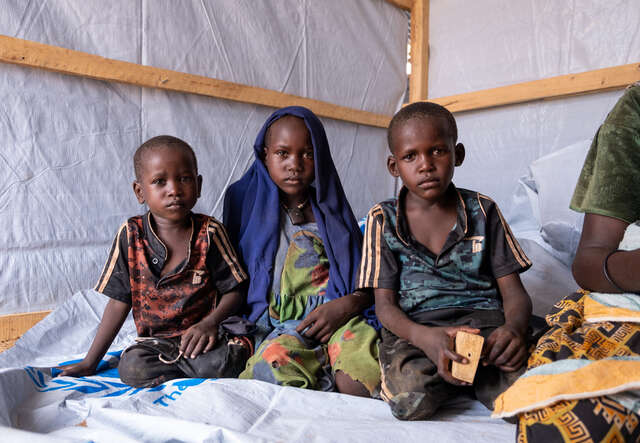 Siblings Nouraddine, Rawiha and Gamaradine (from left to right) in their shelter in Gaga refugee camp, Chad.