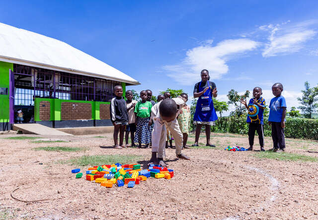 Teacher Enid’s class use LEGO bricks to do counting activities outside.