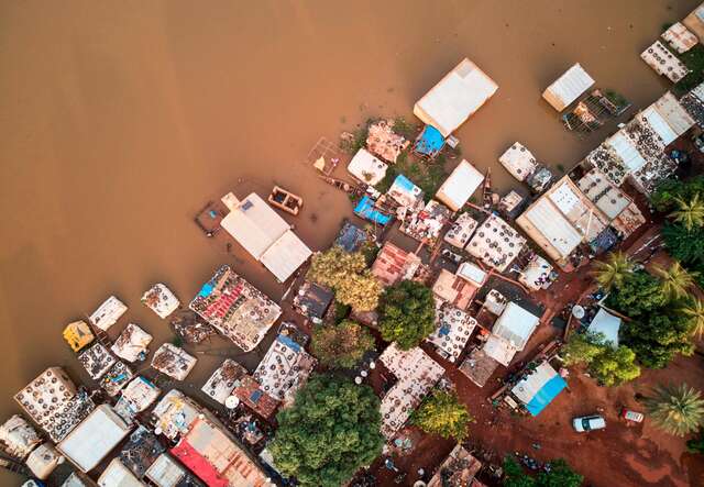 A birds-eye-view of a Malian community that has since been flooded. Brown water inundates homes.