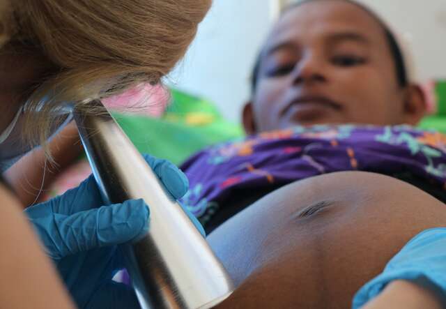 An IRC clinic nurse gives a check up to a pregnant woman in Myanmar.