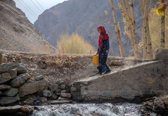 Rozama at the river in her village to collect water for her family. 
