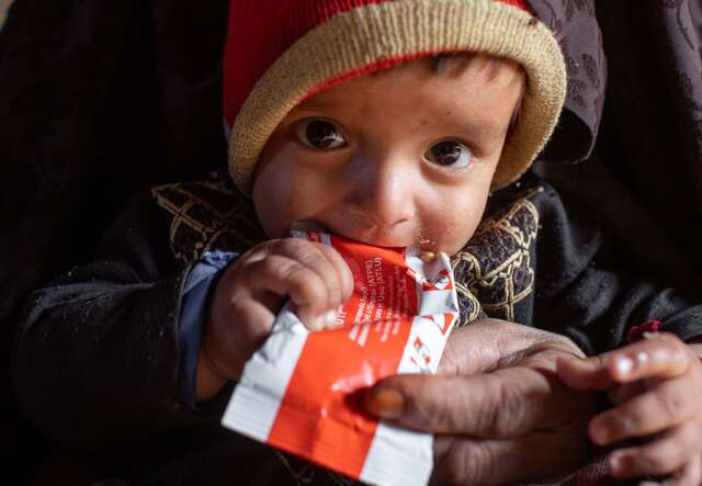 10 month-old Shams Ullah eats a nutrient dense energy food called RUTF provided by the IRC to help him gain weight and fight malnutrition.