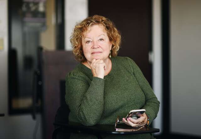 Housing Volunteer, Sylvia, poses for photo in the IRC office.