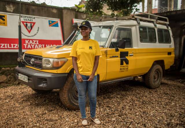 Crisis in the DRC: What you need to know and how to help 4 A female IRC staff member stands in front of an IRC-branded vehicle in the DRC.