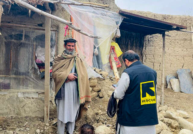 In Afghanistan,  IRC team member conducts an assessment with a man whose family is affected by the recent floods.