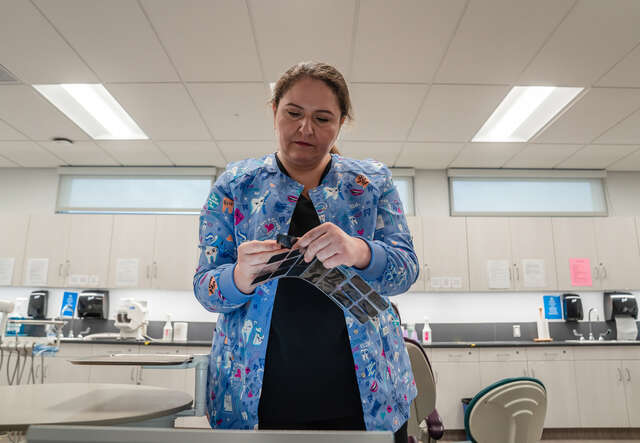 Yuliia in the dentist's room, checking x-rays. 