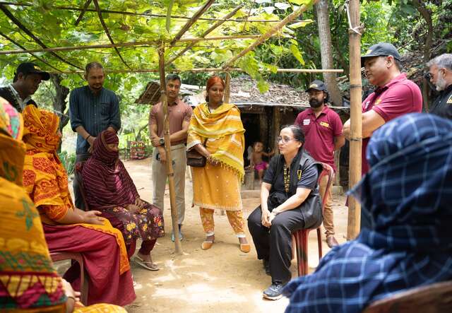 Hasina Rahman speaks with a group of IRC clients, outside at the Cox’s Bazaar refugee camp, Bangladesh.
