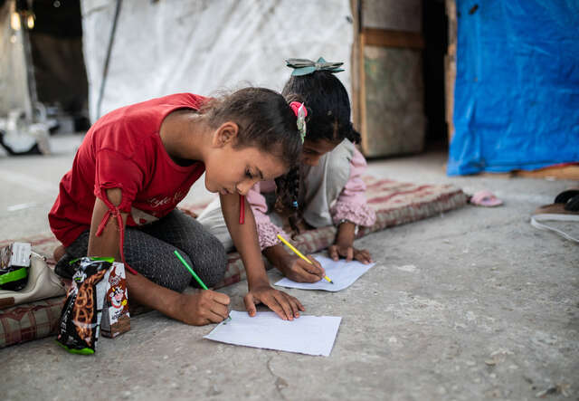 Children drawing as part of a psychosocial support activity held by IRC partner Nafs. 