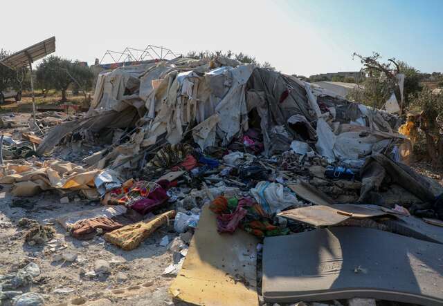 The remains of a tent for displaced persons, with their few belongings burned, after airstrikes targeted a camp in Harbanoush, Syria.