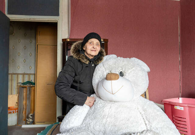 Kateryna holds a teddy bear - a toy belonging to her 18-year-old granddaughter.