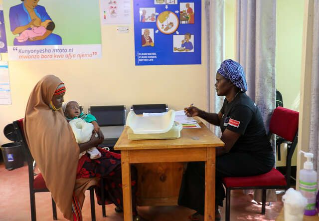 Halima sits at Ammusait General Hospital with her grandson, Abdirashid, waiting for his check-up and a refill of the infant formula she has been receiving since his birth at Ammusait General Hospital in Kakuma, Kenya.