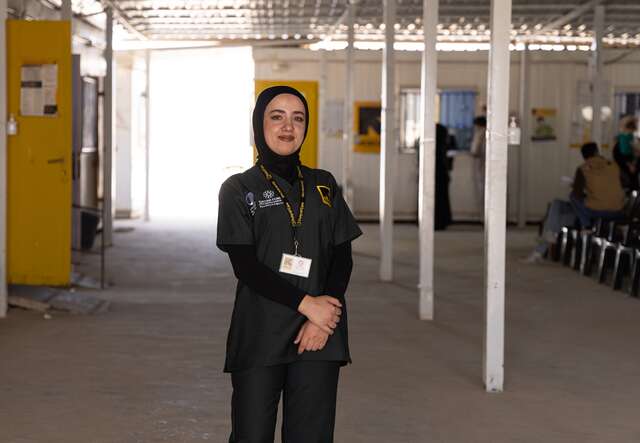 Duha, an IRC nurse, poses proudly at an IRC-run health care facility in the Za'atari refugee camp.