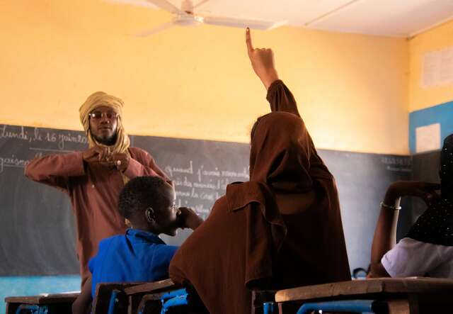Gao, Mali. Teacher Souleymane questioning Samah in class.