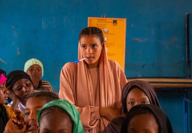Gao, Mali. Samah, 15, standing while being questioned by her teacher.