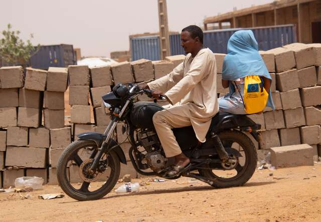Gao, Mali. Samah and her uncle head to school by motorcycle.