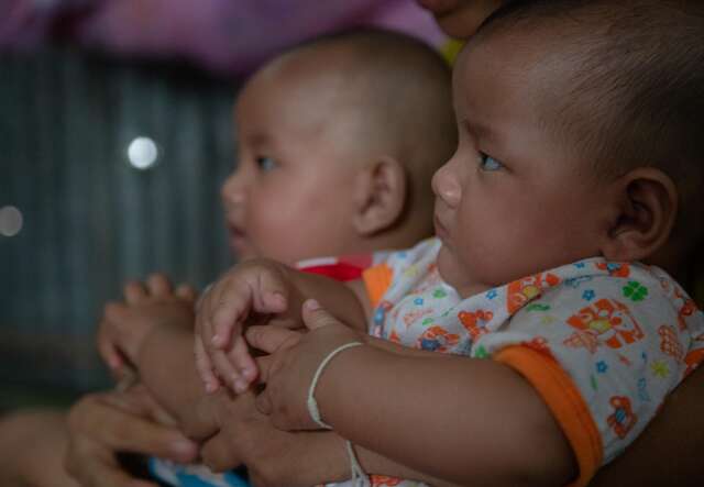 Nwe holding her twins.