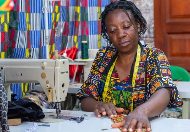 Riziki, a refugee from the Democratic Republic of the Congo, sews at her tailoring studio in Kampala, Uganda.