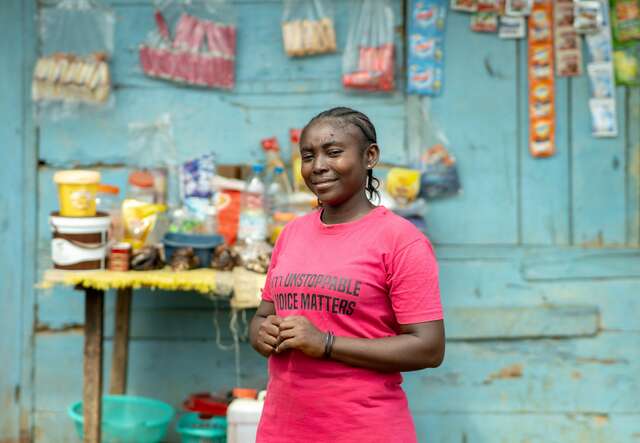 A woman wearing a pink T-shirt 