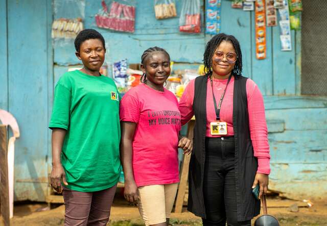 Three women are standing up together