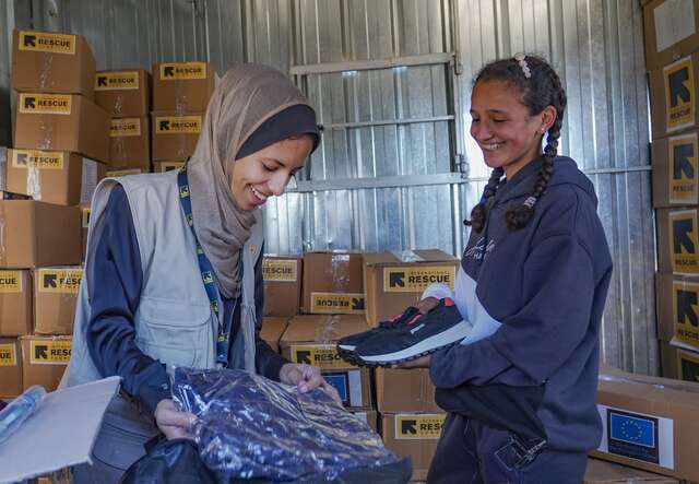A Palestinian girls receives a pair of new shoes from the IRC in Gaza.