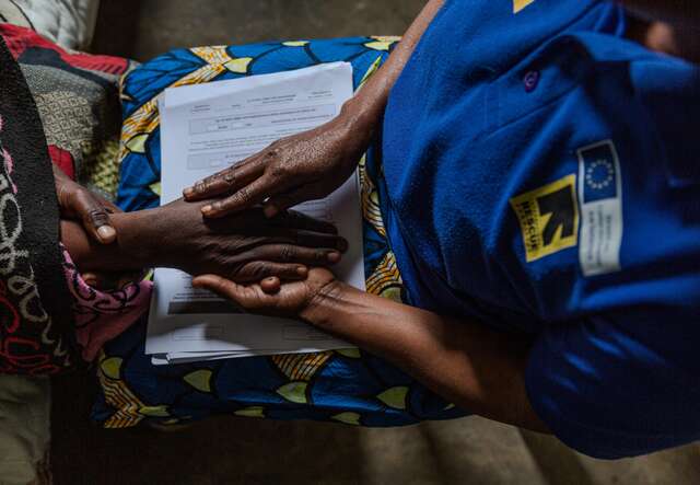An IRC officer offers support to a patient at the Numbi Health Centre in South-Kivu, DRC. 