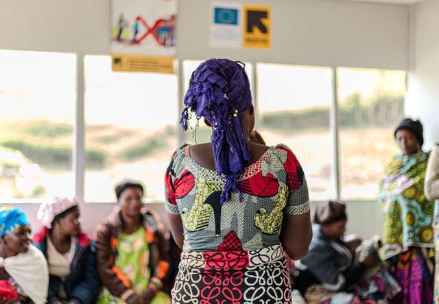 Nadine* addresses her community for a psych-social support session.