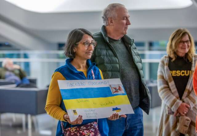 Two IRC supporters prepare to welcome Ukrainians arriving in the US.