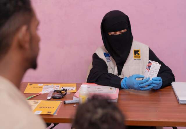 Community health worker Wahda prescribes medicine necessary for Aws to make a full recovery.