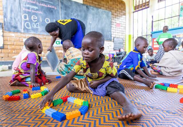 Students play with LEGO blocks in a classroom in western Uganda.
