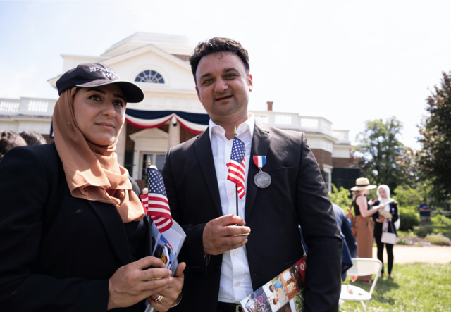 Woman with American flag standing next to man with American flag.