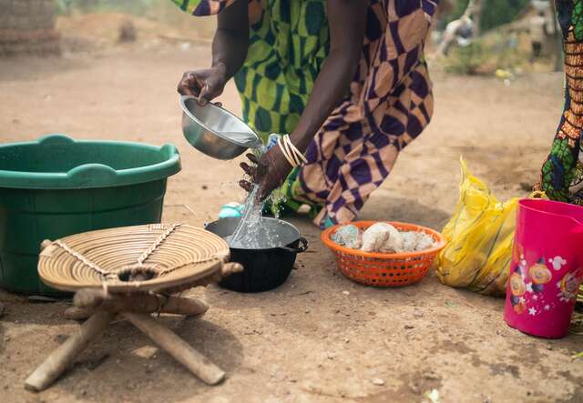 Andrienne washes her hands at home in Vacap after collecting safe water from the new well.