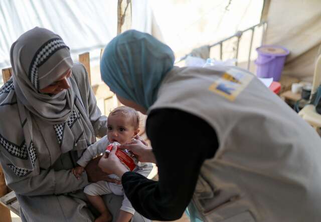 An infant in Gaza is treated for malnutrition by an IRC health worker.