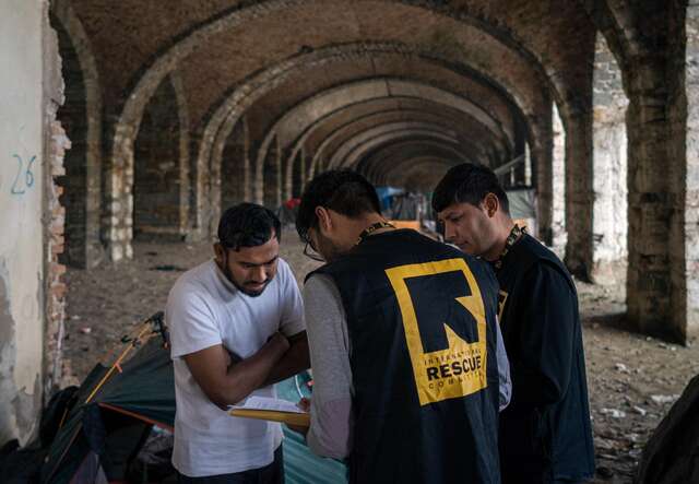 IRC staff members speak with an asylum seeker in Italy.