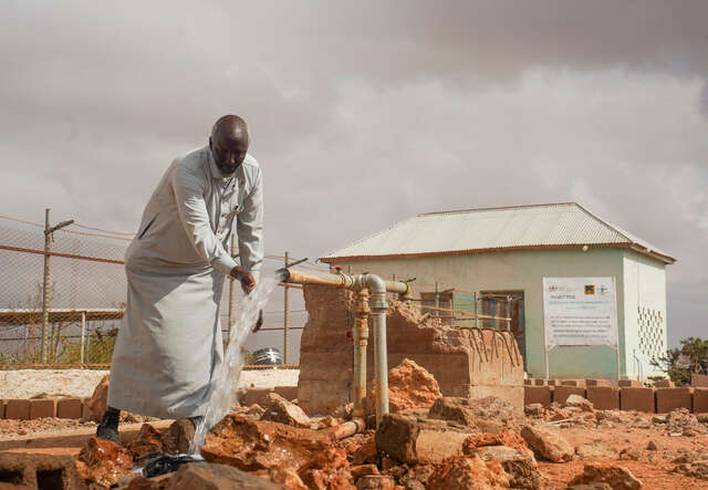 Abdirashid Mohamed Hirsi testar en ny vattenpump som RESCUE har installerat.