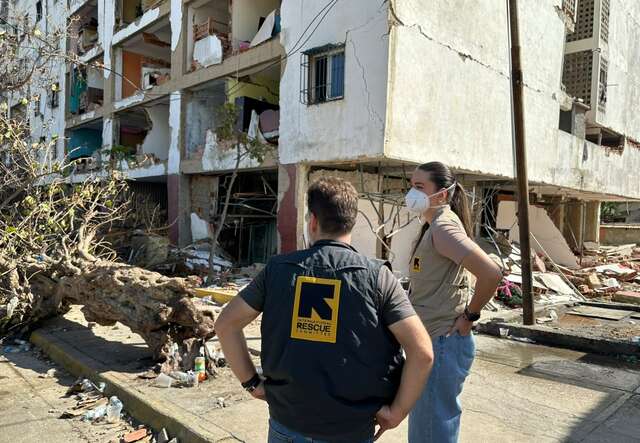 Two IRC staff members assess the ruins of a building destroyed by the earthquakes in Venezuela.