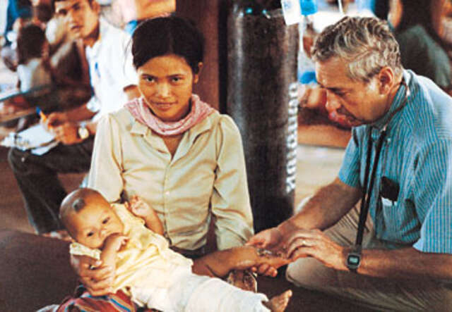 Photo of Dr. Strickler tending to a patient.