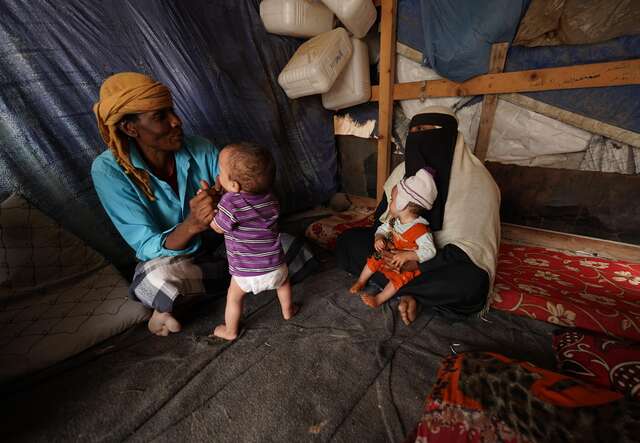 Asriya and her husband and their two twins, then aged one.