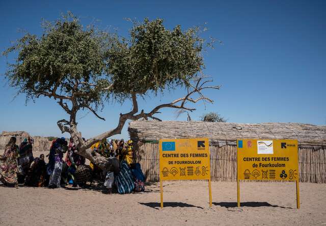 Women gathered under the shade outside the EU-funded IRC Women’s Center in Fourkouloum, Chad before the start of the day’s activities. 