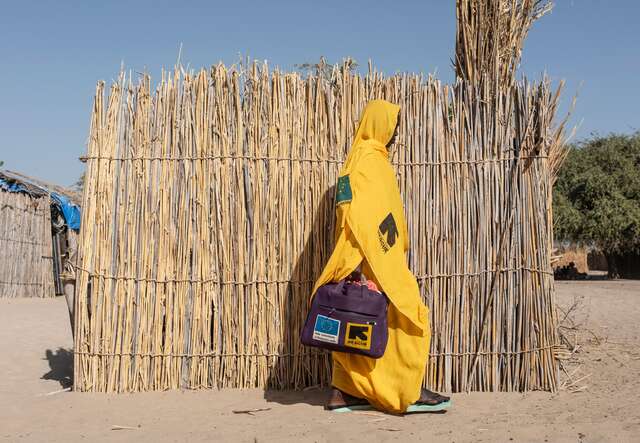 Bintou leaves her home in Tagal to talk with parents in her community about feeding practices.